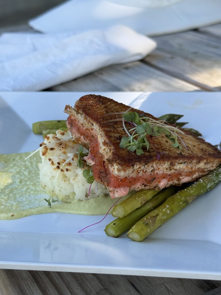 Asian inspired seared tuna stake over rice and asparagus spears